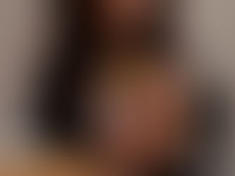 A hand holding a custom playing card deck with personalized artwork, surrounded by packaging and printing tools.