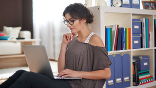 Student studying on a laptop researching human behavior concepts, representing a bachelors degree applied psychology and flexible online learning in psychology programs