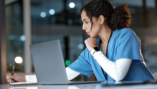 Student studying on a laptop analyzing population health data, representing a bachelors degree public health and flexible online learning in public health programs