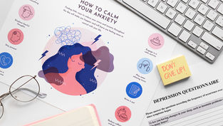 Mental health concepts and materials for a master’s degree in psychology online, with notes, laptop, and wellness resources on a desk.