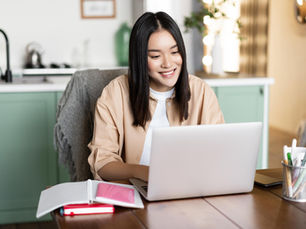 Student studying on a laptop while earning a bachelor’s degree in business administration online through a flexible university program.