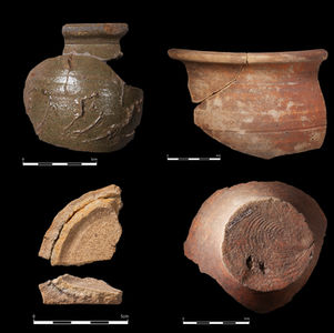 Four pottery fragments displayed on a black background, showing different shapes, textures, and signs of wear.