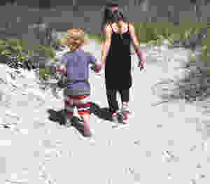 kids walking along the beach hand in hand