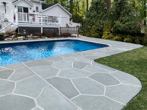 Upgraded concrete pool deck in Granite Slate finish with a clean gray slate look.