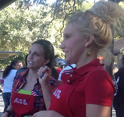 two female ASL students volunteering at an event
