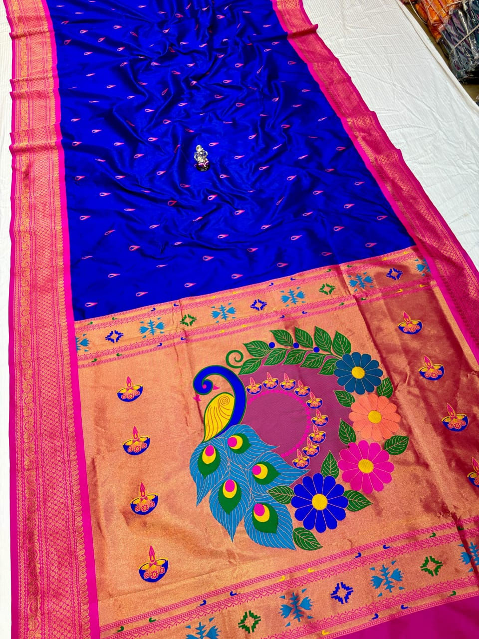 Navy blue Paithani soft silk saree featuring bold peacock motif.