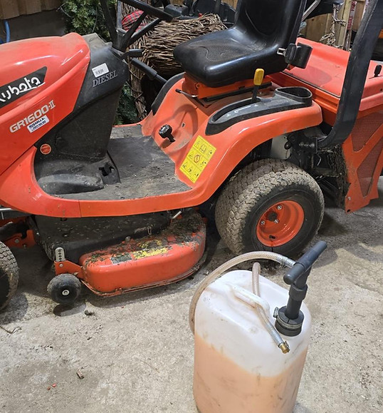 sealant pump attached to 25ltr container of sealant and to a ride-on lawnmower wheel