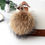 Thumbnail: Raccoon Fur Ball Bag Charm in Natural Tan
