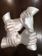 Family holding hand sculpture