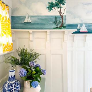 Hand-painted mural of an ocean seascape, featuring sailboats and trees for a vintage Nova Scotia vibe.