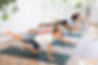 Concentrated children performing asana Dandyamana Brahmanaasana during group yoga course i
