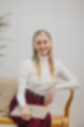 Antalia Terblanche sitting on a chair with her laptop on her lap