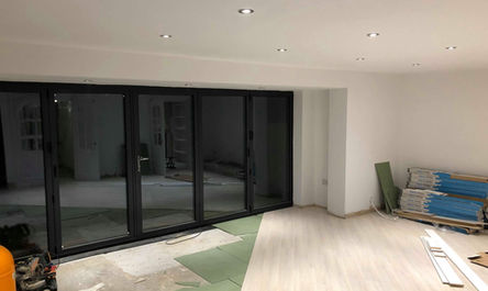 A garage conversion that is being remodeled with a sliding glass door.