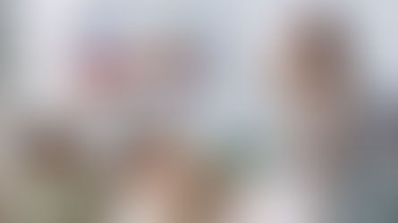 A speech therapist works with a group of young children in a classroom setting, practicing speech exercises