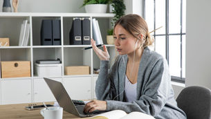 Insurance billing staff looking confused while reviewing overpayment details on medical claims.