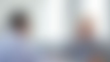 Insurance representative explaining coverage benefits to a patient in a modern office setting, symbolizing trust and clarity in healthcare insurance discussions.