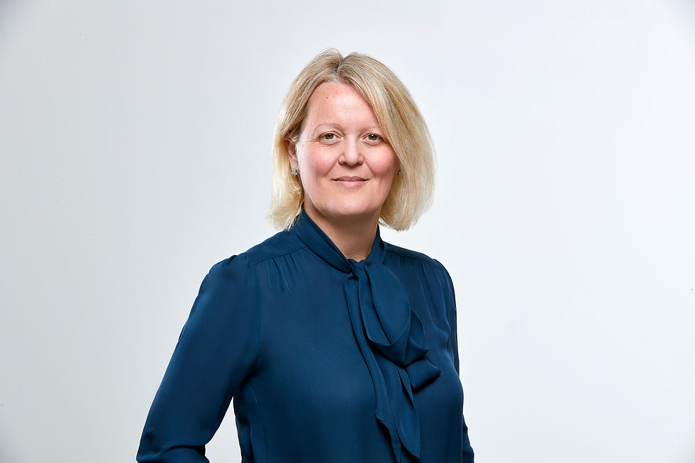 Professional headshot of Dame Alison Rose wearing a navy blouse with a bow collar, posed against a plain light background, reflecting her role as a pioneering figure in British banking leadership.