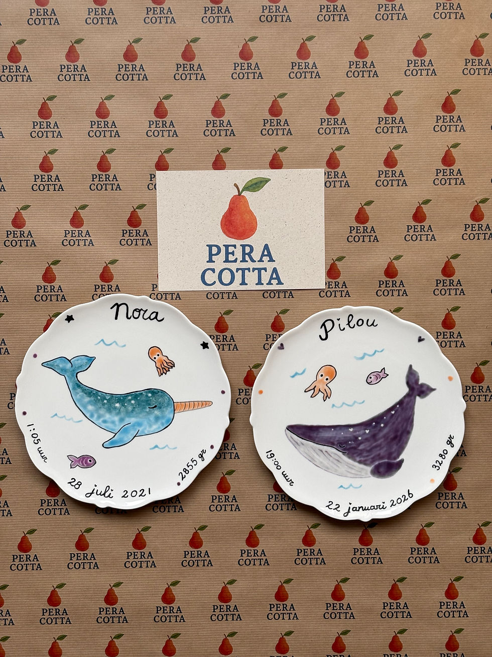 Hand-painted personalised birth plates featuring whale desings on ceramic.