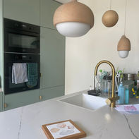 Custom hand-painted ceramic tile, with four shells, in a wooden frame, displayed in kitchen