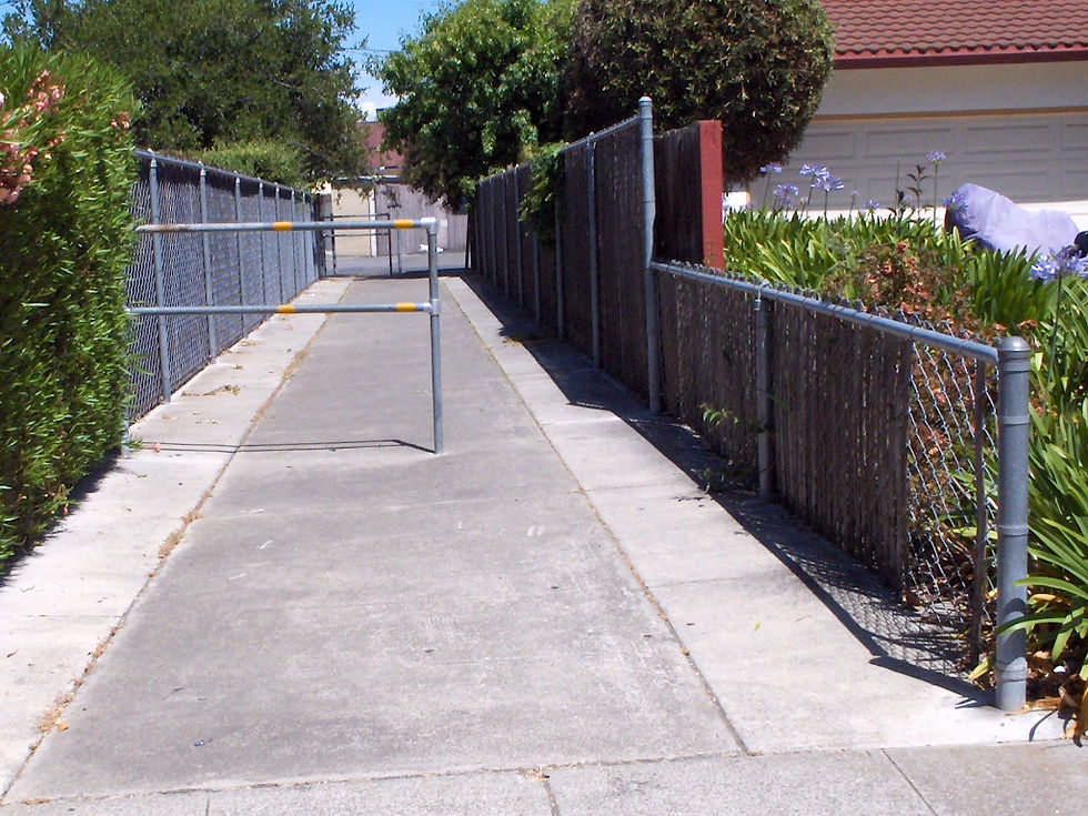 Violating the Caltrans Highway Design Manual, this barrier at the east end of Yorktown creates an asymmetric single-lane passage.