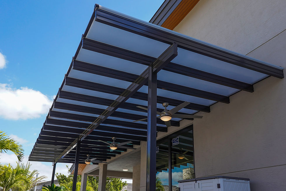 Modern aluminum pergola with steel-framed louvered roof casting shade over a luxury Miami patio