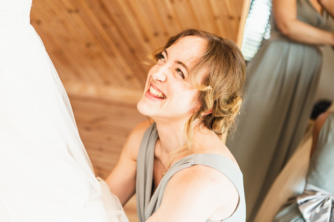 Bride gets into wedding dress at Sylen Lakes as photographer captures the moment