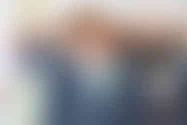 groomsman laughs at wedding photographer captures natural photo of him