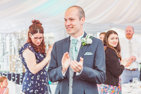 groom applauds at sylen lakes wedding breakfast room