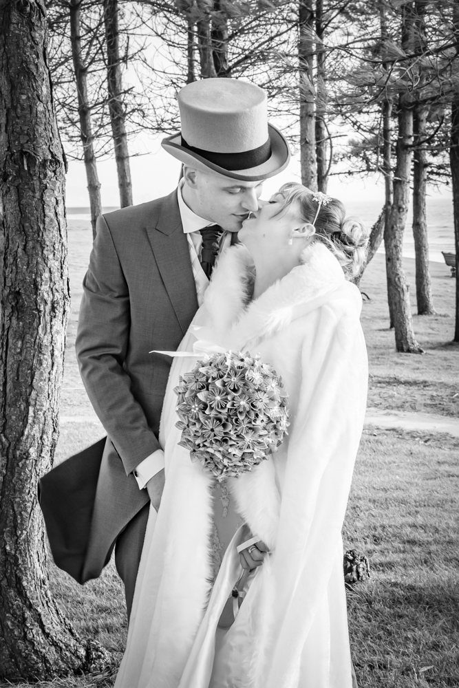 bride and groom pose for a Swansea and Gower documentary photographer