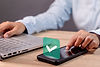 woman-using-smartphone-with-green-checkmark-screen-validated-confirmed-completed-approved.
