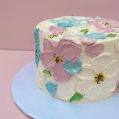 A modern textured designer cake with colorful buttercream palette knife flowers