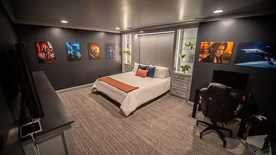 We transformed this space into the ultimate gamer's dream by designing a moody, immersive entertainment room that doubles as a highly functional guest bedroom. Recognized as a 2024 Merit Winner for Creative Solutions, this project features a hidden Murphy bed seamlessly integrated into beautiful custom cabinetry, delivering a supreme gaming experience without sacrificing versatile living space.