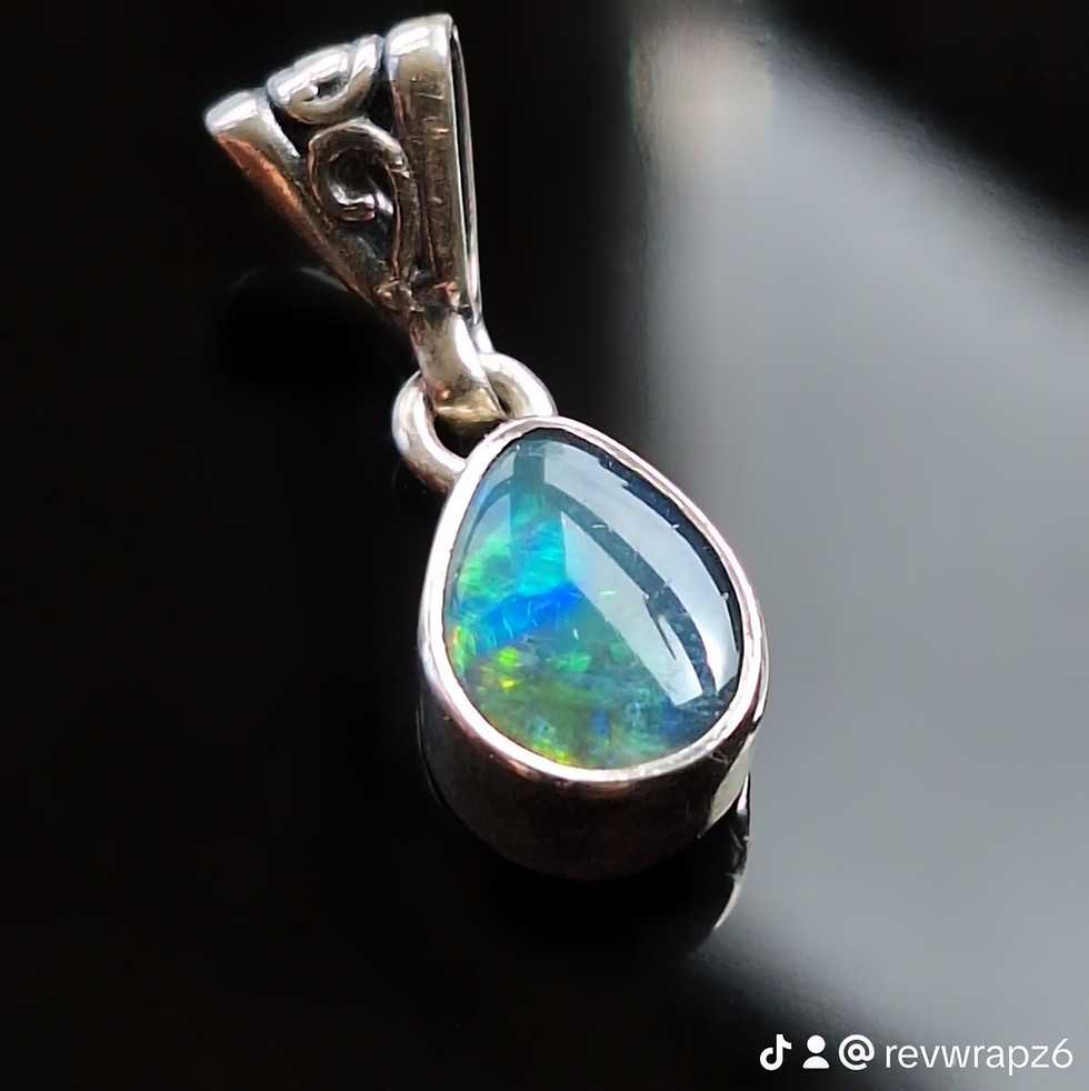 Lightning Ridge opal doublet pendant with vivid blue-green fire on a dark base, front view.