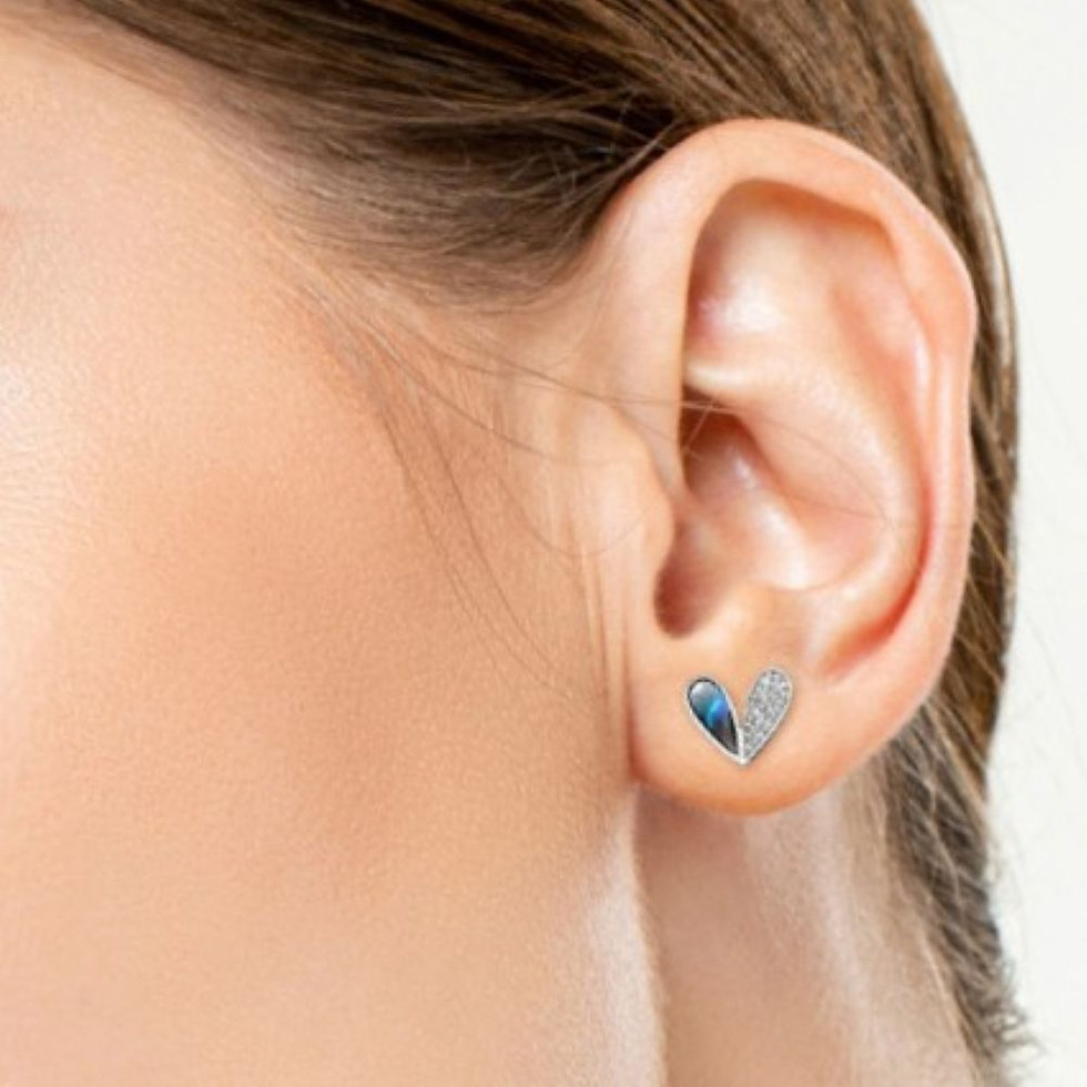 Sterling silver heart stud earrings with natural abalone shell and cubic zirconia accents, pictured on a model.