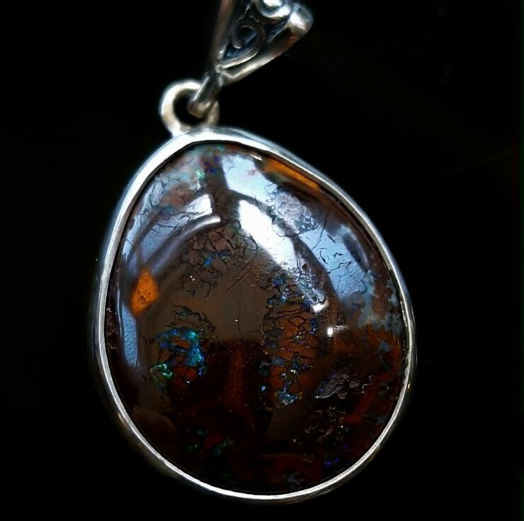 Handcrafted sterling silver necklace featuring a freeform polished Queensland boulder opal stone. front view