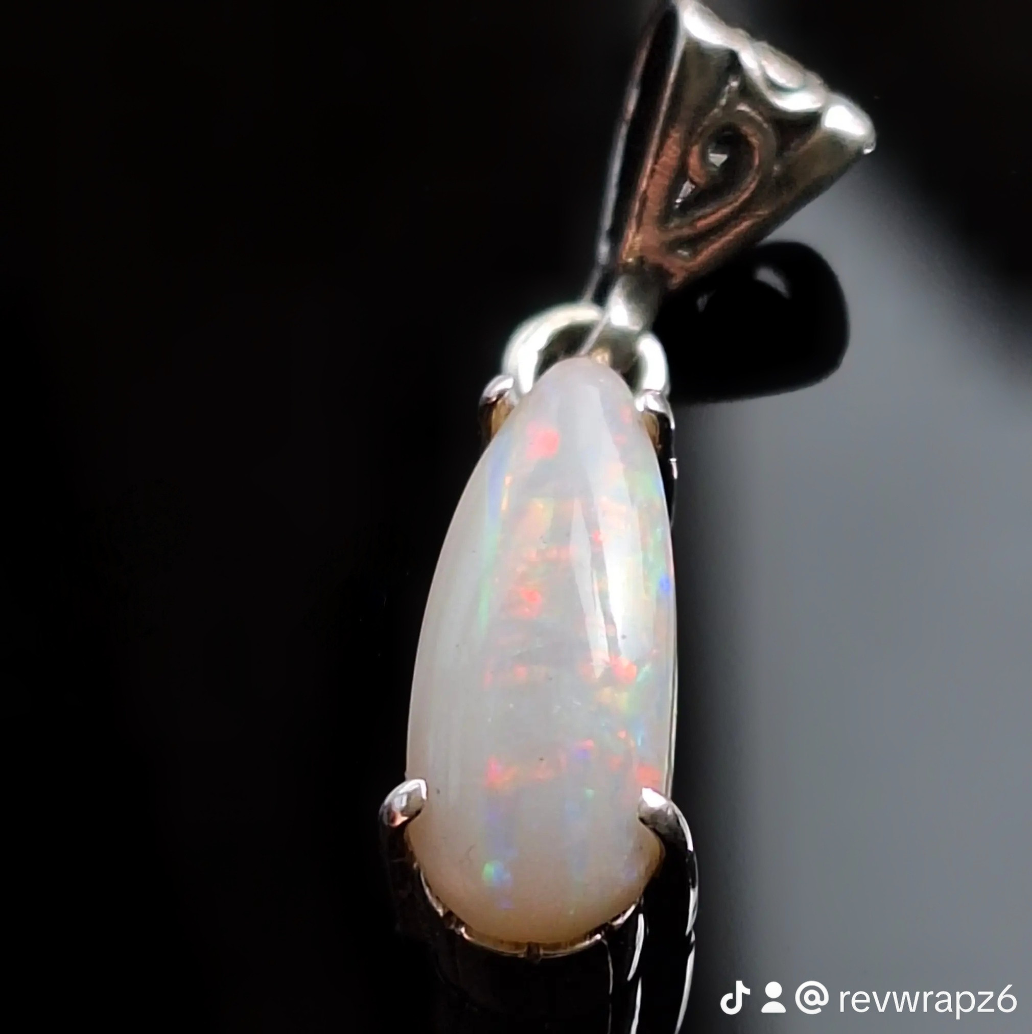 Coober Pedy CP Olympic solid opal claw pendant with vibrant red, green, and blue fire. front view
