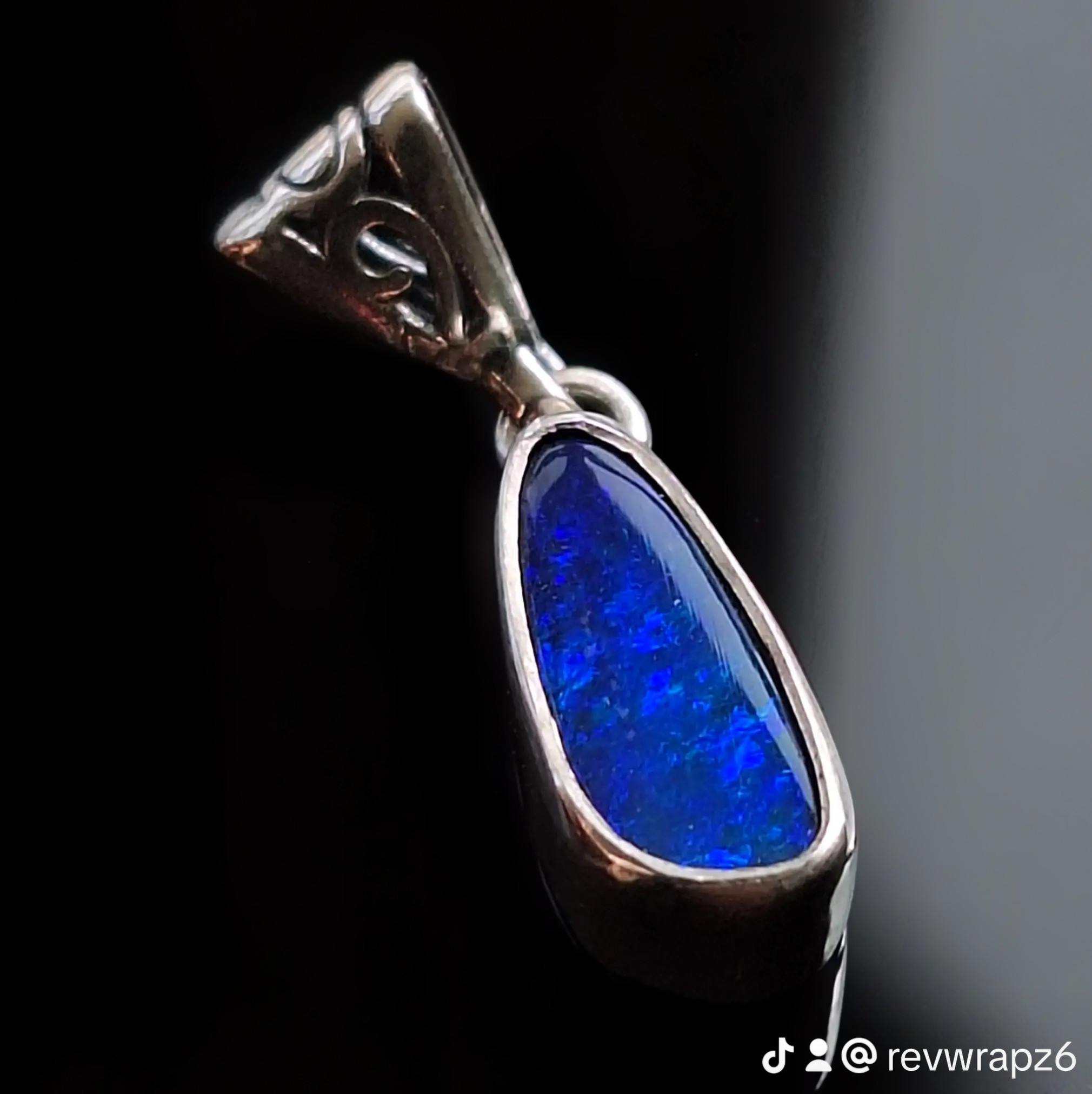 Lightning Ridge opal doublet pendant with vivid blue-green fire on a dark base, front view