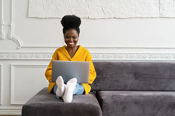 10 steps to solopreneur success a black lady sitting with legs up and a laptop on her lap smiling