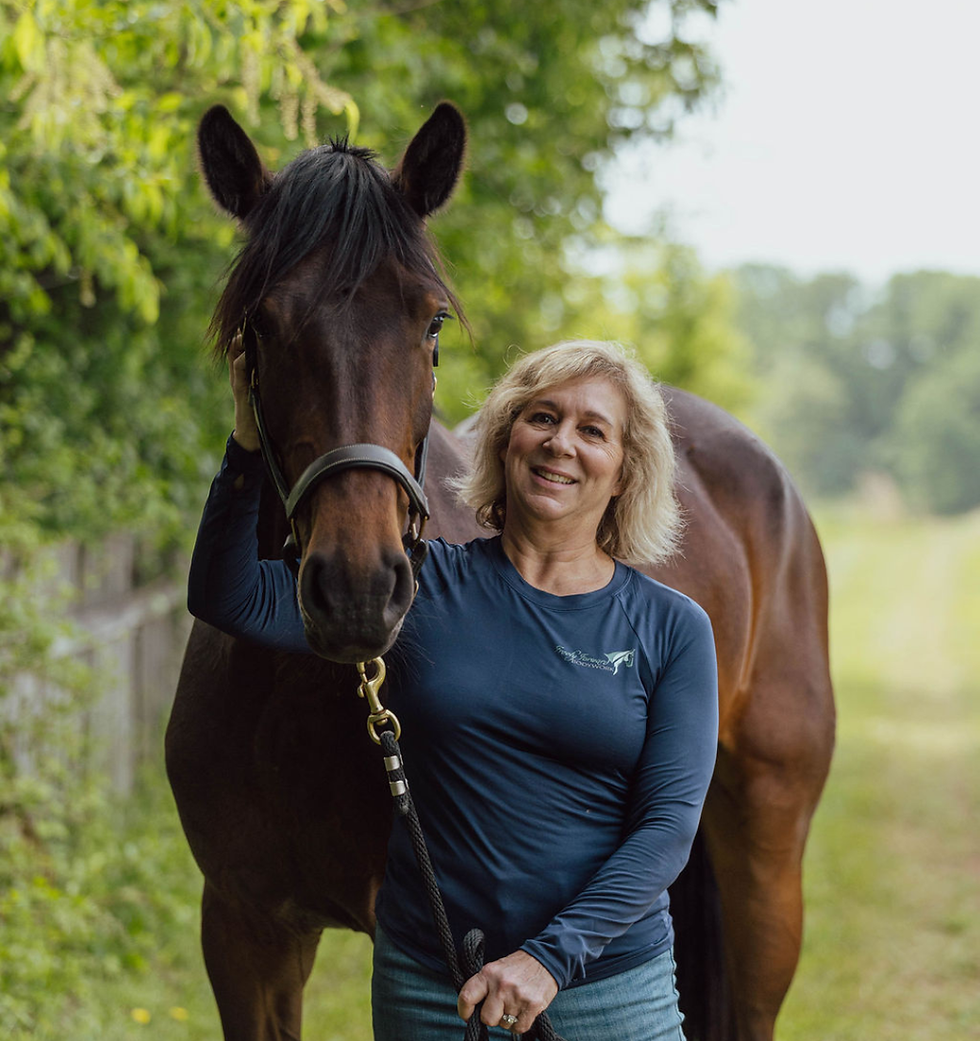 Owner Regina Doherty standing with a happy horse