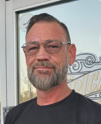 Picture of Lawler, adult man wearing black american tattoo company tshirt