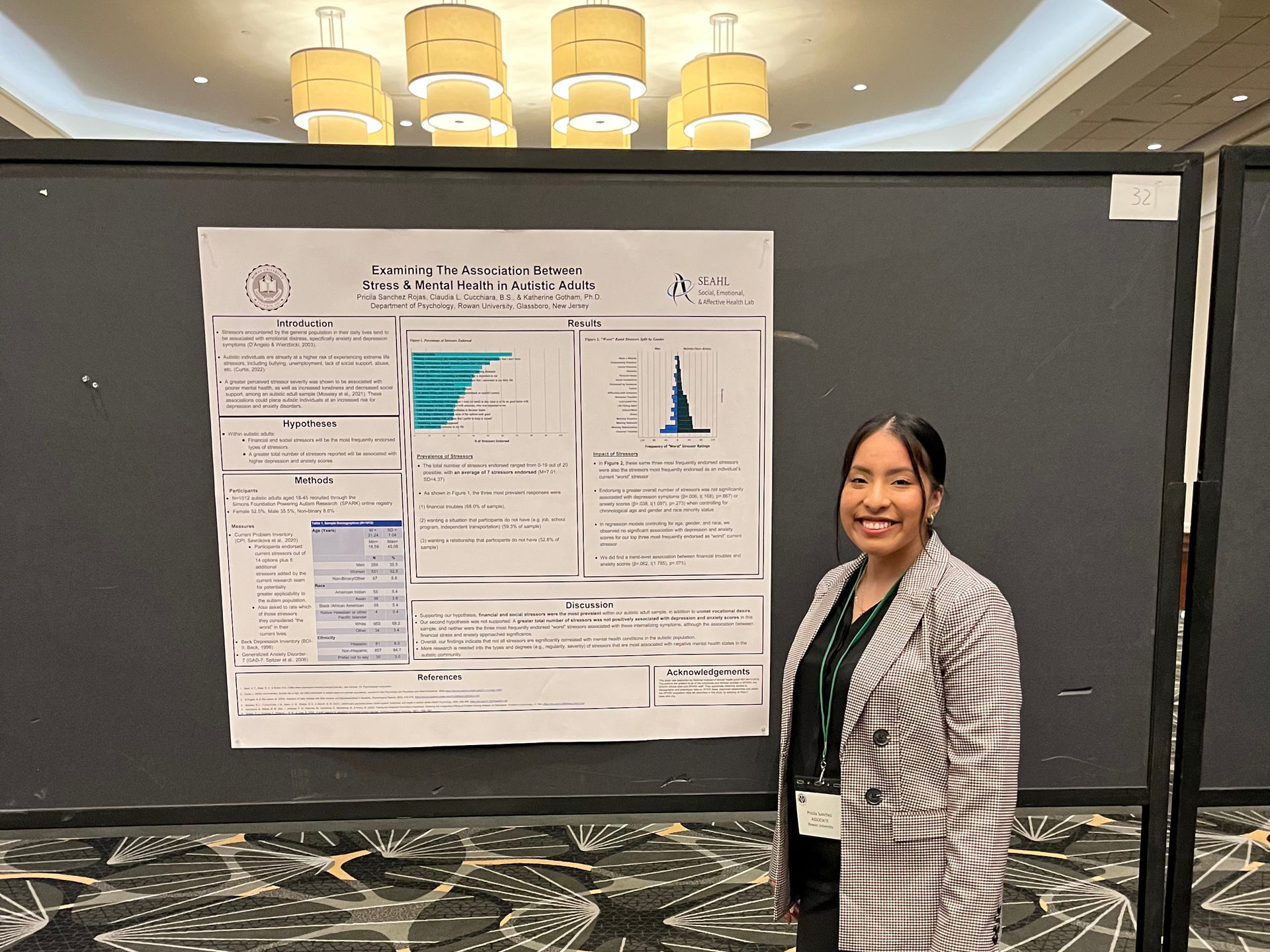 Pricila standing in front of her research poster.
