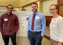 Christ, Trey, and Kaite standing in front of a research poster.