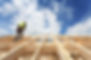 Construction crew working on the roof against blue sky.jpg