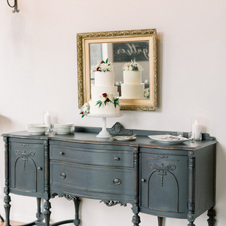 vintage black sideboard is focal point for the wedding cake at The Loft of Elements Preserved