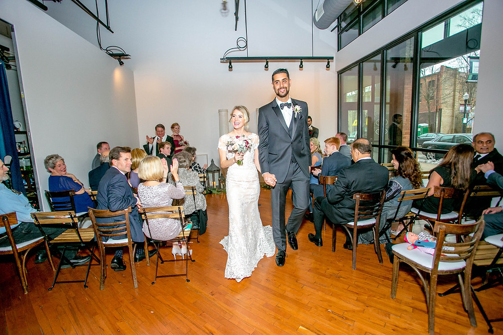 bride and groom recessional following tiny elopement wedding at Loft of Elements Preserved in Elgin, IL