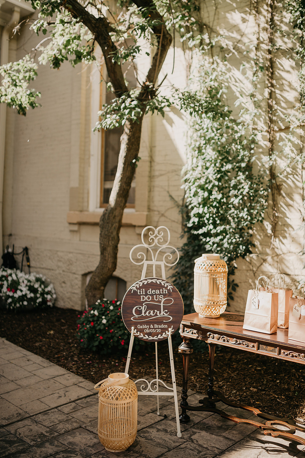 Wicker lantern decor and signage welcome guests to intimate wedding