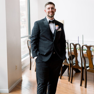 groom posing for photographer