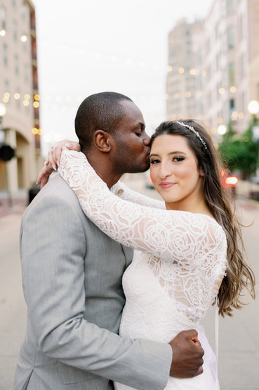 Bride and Groom pose in the middle of the street