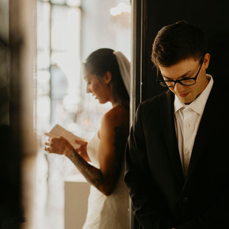 groom is in deep thought as he hears his bride share her vows