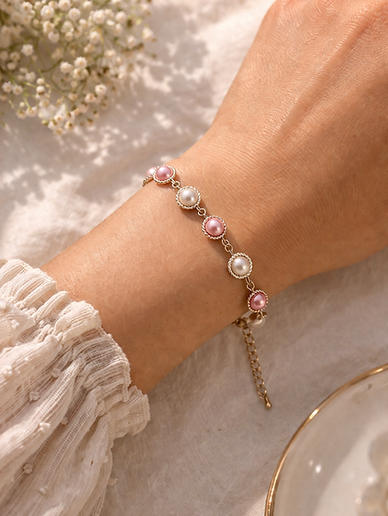 pearly girl on wrist.png